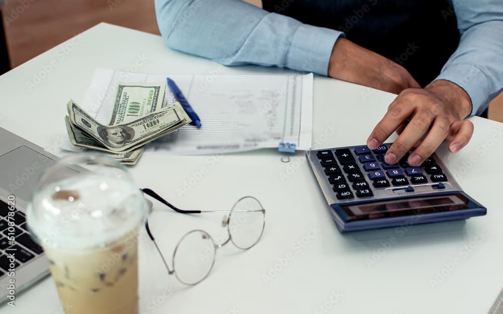 A coffee shop owner counts costs.